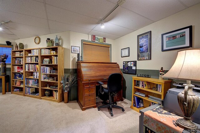 carpeted home office with track lighting and a drop ceiling