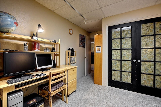 carpeted office with french doors, a drop ceiling, and track lighting