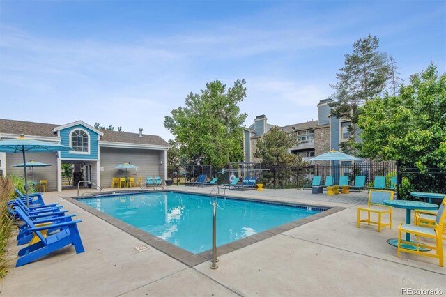 pool featuring a patio area and fence