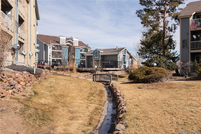 view of yard with a residential view and fence