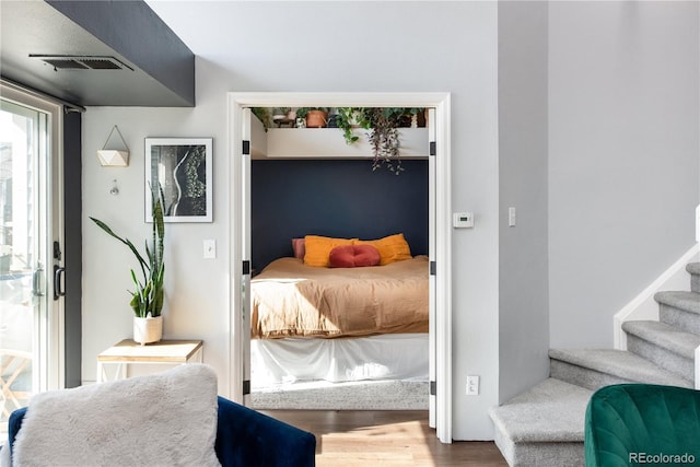 bedroom with wood finished floors and visible vents