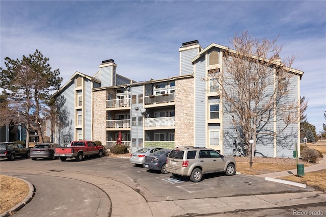 view of building exterior with uncovered parking