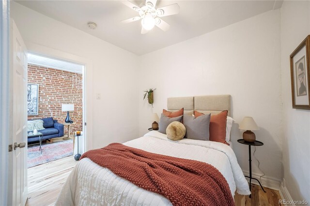 bedroom featuring wood finished floors, access to outside, baseboards, and ceiling fan