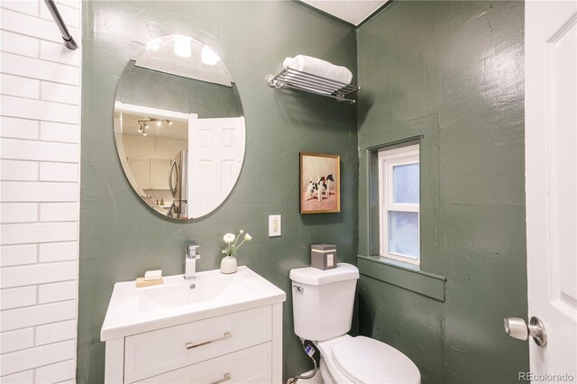 bathroom featuring toilet and vanity