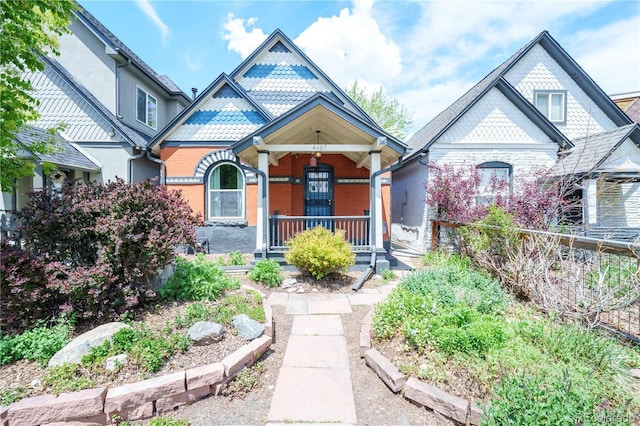 victorian-style house with covered porch and brick siding