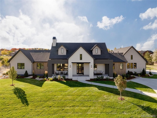 modern farmhouse style home featuring a front yard