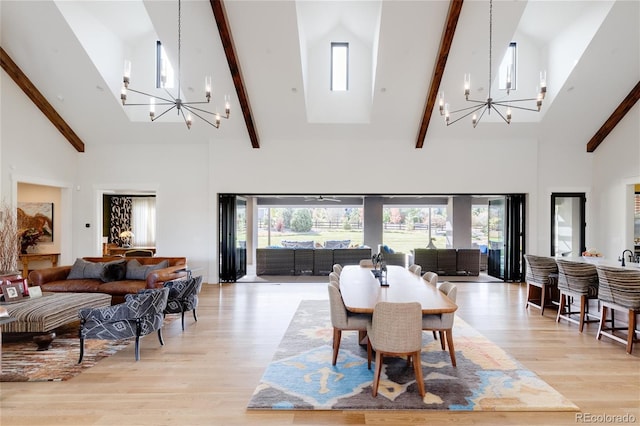 dining room with high vaulted ceiling, a wealth of natural light, a chandelier, and light wood-type flooring