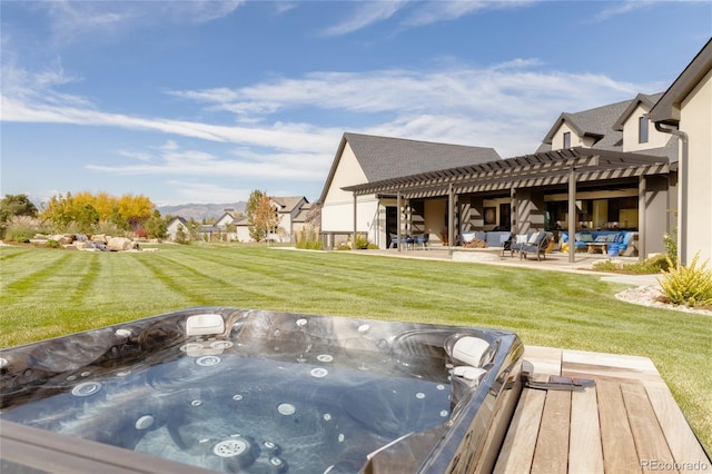 exterior space featuring a pergola, a hot tub, a yard, and a patio