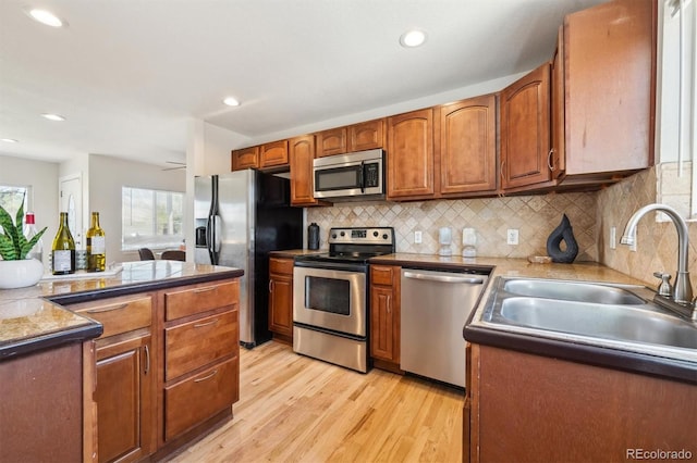 2285 Fulton St, Aurora, CO 80010 - kitchen featuring stainless steel appliances, a sink, light wood-type flooring, backsplash, and recessed lighting
