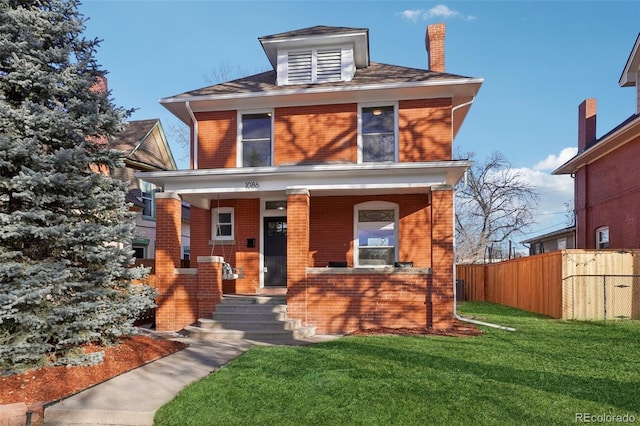 view of front of home with a porch and a front yard