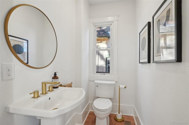 bathroom featuring sink and toilet