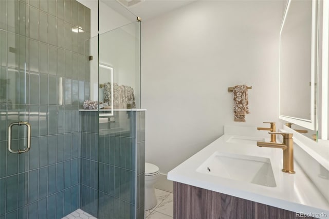 bathroom featuring toilet, an enclosed shower, and vanity