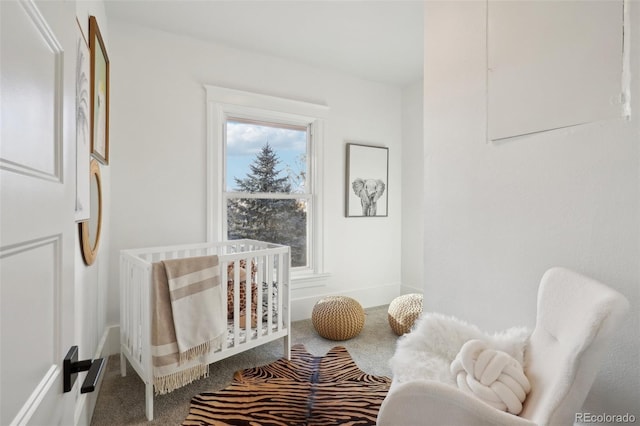 carpeted bedroom with a nursery area