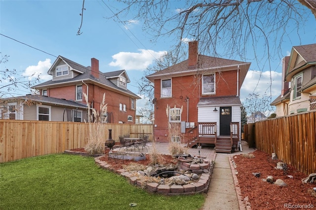 rear view of property with a yard and a patio area