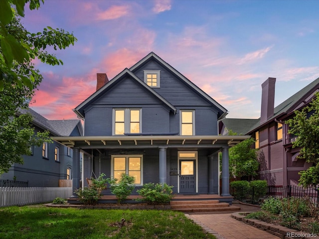1423 Elizabeth St, Denver, CO 80206 - view of front facade featuring covered porch, a chimney, and fence
