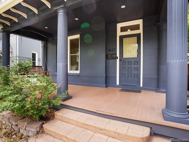1423 Elizabeth St, Denver, CO 80206 - doorway to property featuring brick siding and covered porch