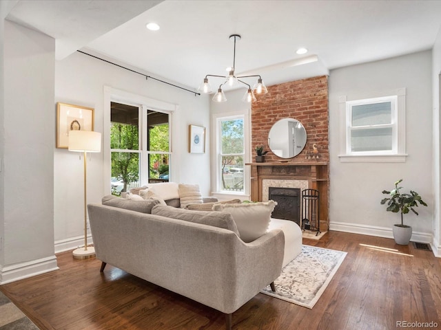 1423 Elizabeth St, Denver, CO 80206 - living area featuring baseboards, a chandelier, dark wood finished floors, a fireplace, and recessed lighting