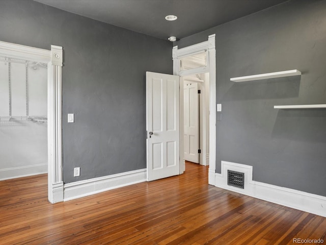 1423 Elizabeth St, Denver, CO 80206 - unfurnished bedroom featuring wood finished floors, baseboards, a closet, and a spacious closet