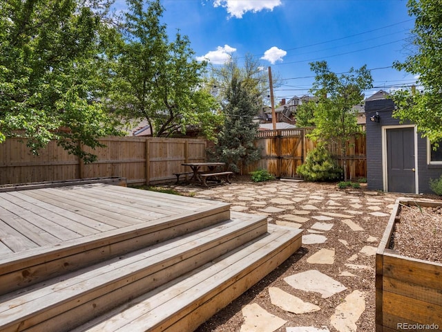 1423 Elizabeth St, Denver, CO 80206 - deck featuring a fenced backyard, an outdoor structure, and a shed