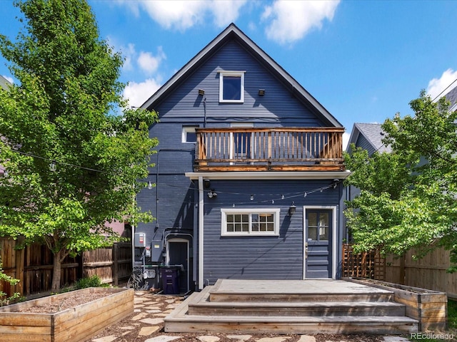 1423 Elizabeth St, Denver, CO 80206 - rear view of property with a balcony, a vegetable garden, fence, and a wooden deck