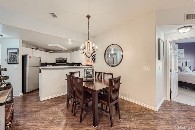 dining room featuring a notable chandelier and dark hardwood / wood-style floors