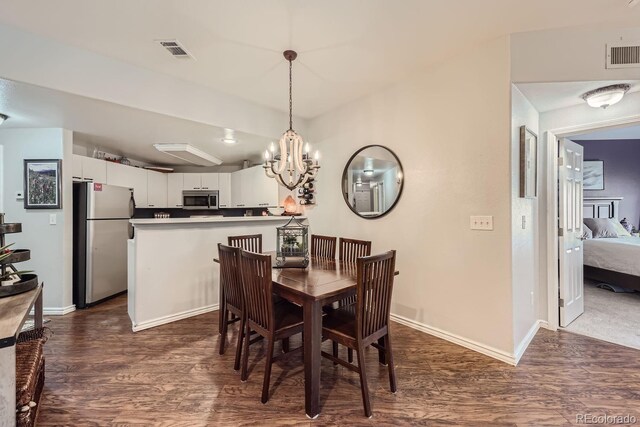 8767 E Dry Creek Rd Unit 1312, Englewood, CO 80112 - dining area featuring dark wood-type flooring, baseboards, and a chandelier