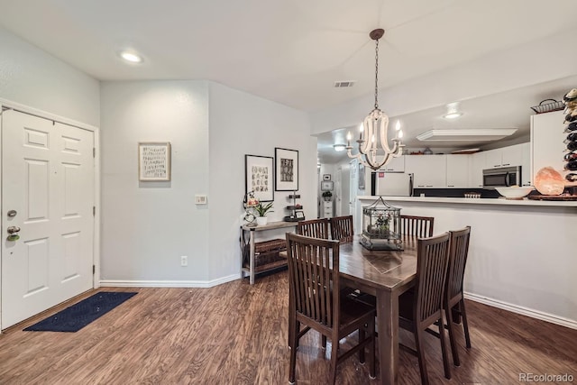 dining area with dark hardwood / wood-style floors