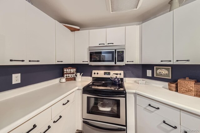 8767 E Dry Creek Rd Unit 1312, Englewood, CO 80112 - kitchen with appliances with stainless steel finishes, light countertops, and white cabinetry
