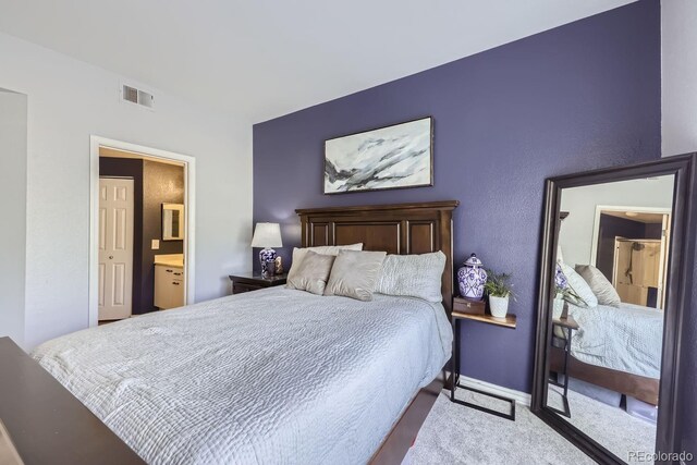 8767 E Dry Creek Rd Unit 1312, Englewood, CO 80112 - carpeted bedroom with ensuite bath and baseboards