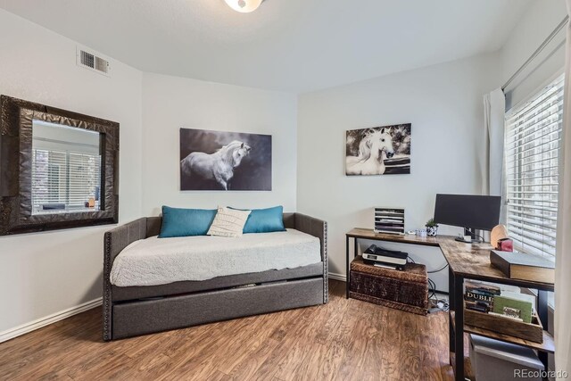8767 E Dry Creek Rd Unit 1312, Englewood, CO 80112 - bedroom with wood finished floors, a desk, and baseboards