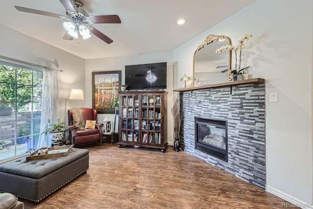 sitting room featuring hardwood / wood-style flooring, ceiling fan, and a fireplace