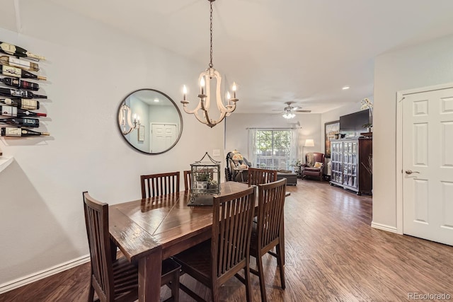 dining room featuring dark hardwood / wood-style floors and ceiling fan with notable chandelier