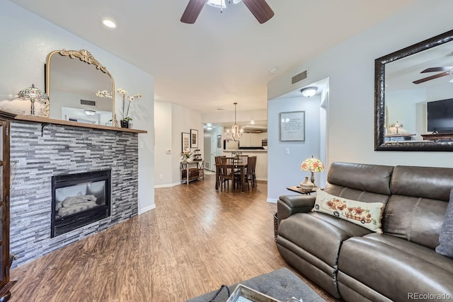 living room featuring hardwood / wood-style floors, a fireplace, and ceiling fan