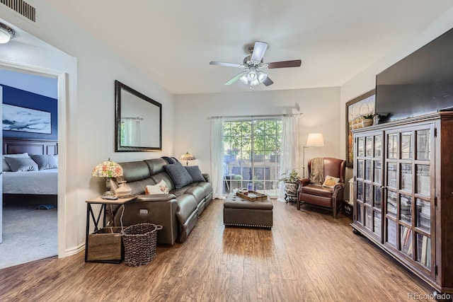 living room with hardwood / wood-style flooring and ceiling fan