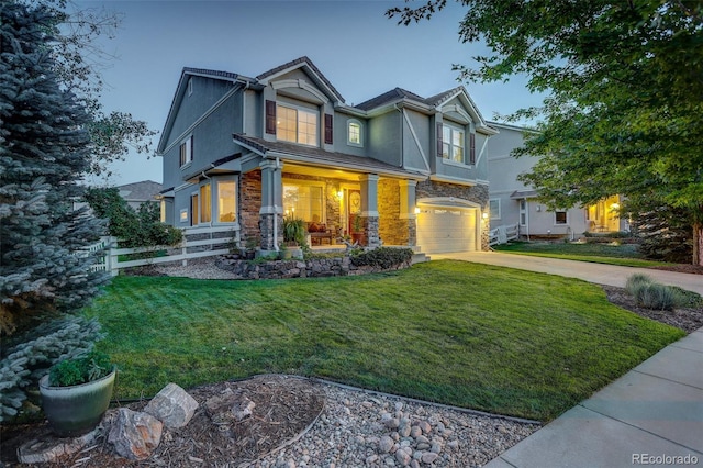 craftsman house featuring a lawn and a garage