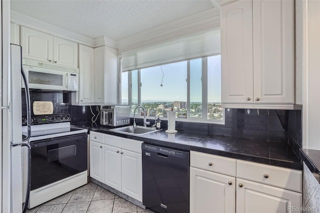 kitchen featuring white cabinets and white appliances