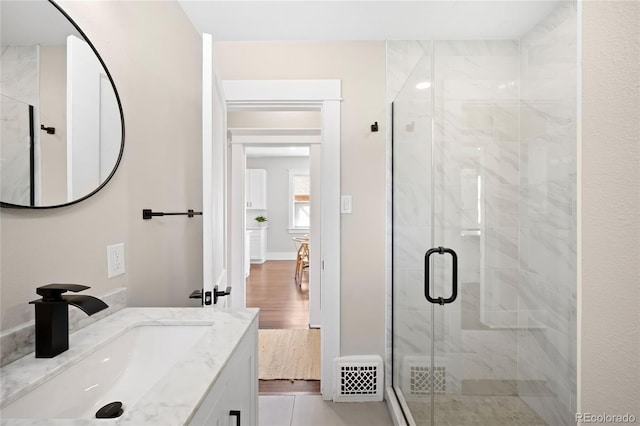 bathroom featuring a shower stall, vanity, and visible vents