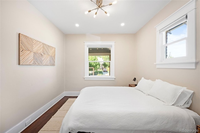 bedroom featuring baseboards, dark wood-style flooring, a chandelier, and recessed lighting