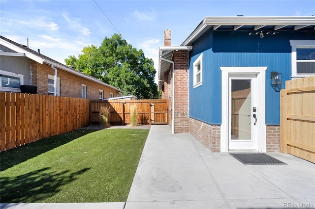 exterior space featuring a fenced backyard, a gate, and a patio