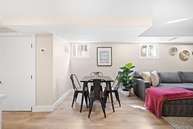 dining area featuring baseboards, visible vents, and light wood-type flooring