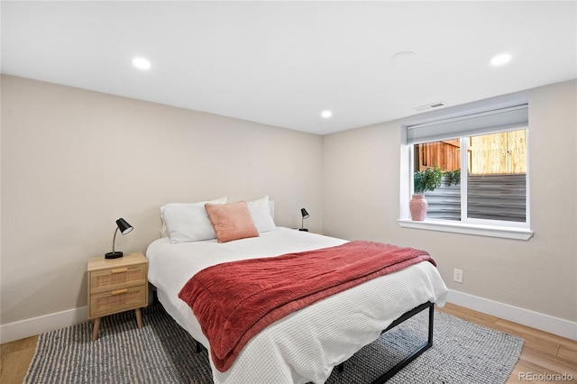 bedroom featuring recessed lighting, light wood-style floors, visible vents, and baseboards
