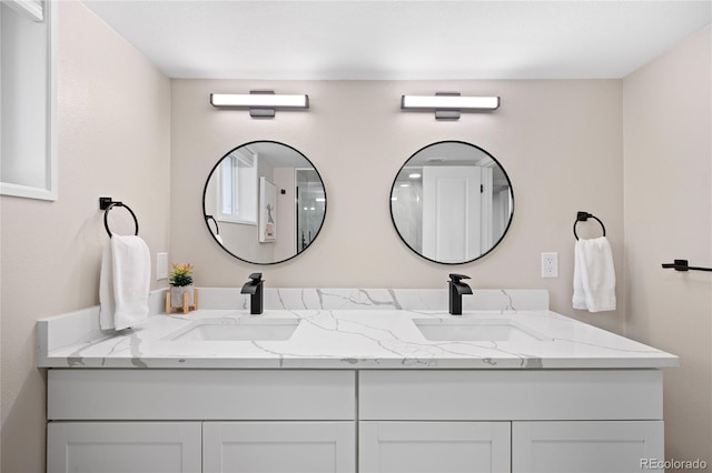full bathroom with double vanity and a sink
