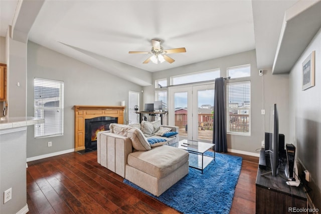 4481 Kingfisher Pt, Colorado Springs, CO 80922 - living area with a ceiling fan, dark wood finished floors, a fireplace with flush hearth, baseboards, and lofted ceiling