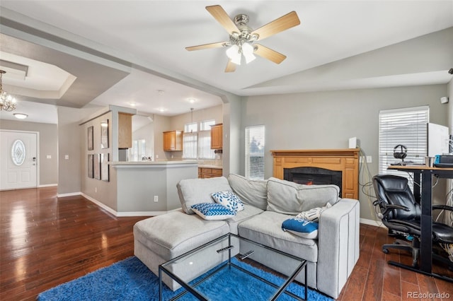 4481 Kingfisher Pt, Colorado Springs, CO 80922 - living room with dark wood-style flooring, a lit fireplace, baseboards, and a ceiling fan