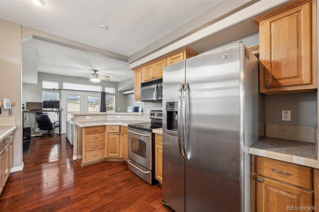 4481 Kingfisher Pt, Colorado Springs, CO 80922 - kitchen with stainless steel appliances, a peninsula, dark wood finished floors, a ceiling fan, and a desk