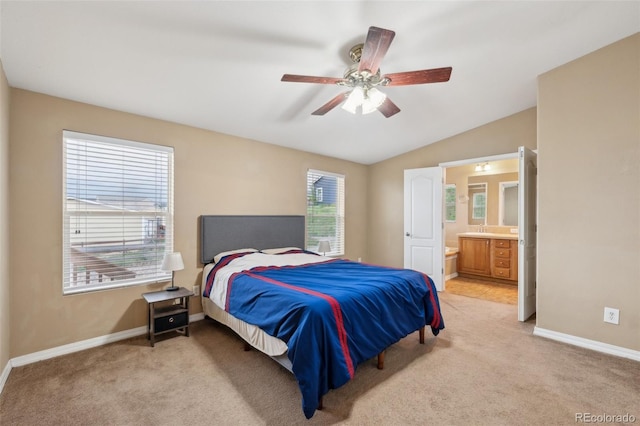 4481 Kingfisher Pt, Colorado Springs, CO 80922 - bedroom with baseboards, light colored carpet, vaulted ceiling, and ensuite bathroom