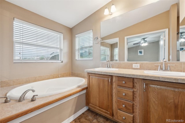 4481 Kingfisher Pt, Colorado Springs, CO 80922 - full bath with double vanity, a garden tub, tile patterned floors, a ceiling fan, and lofted ceiling