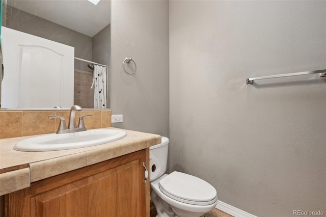 4481 Kingfisher Pt, Colorado Springs, CO 80922 - bathroom with toilet, vanity, and a shower with curtain