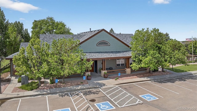 4481 Kingfisher Pt, Colorado Springs, CO 80922 - view of front facade with uncovered parking, a porch, and roof with shingles