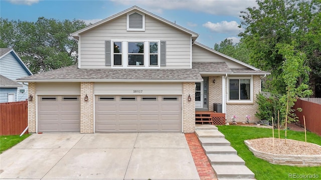 10517 Clermont Way, Thornton, CO 80233 - view of front facade featuring brick siding, concrete driveway, an attached garage, and roof with shingles